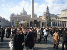 Tim and Miaomiao with the facade of St. Peter`s Basilica, the Vatican Obelisk, a christmas tree and the Nativity of Jesus, at Saint Peter`s Square, right after the Christmas celebrations