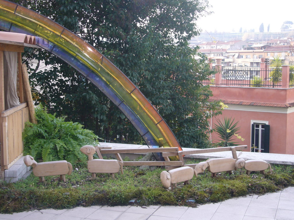 Rainbow and wooden sheep of the Nativity of Jesus along the Viale Vaticano street