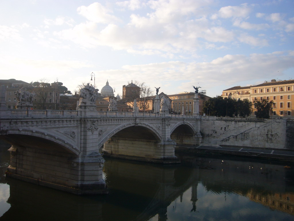The Ponte Vitorio Emanuele II bridge over the Tiber river, and the Dome of St. Peter`s Basilica