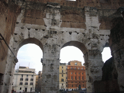 Passage on level 1 of the Colosseum, with view on houses nearby