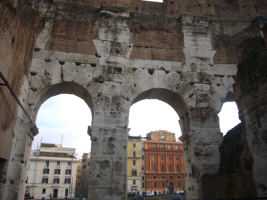 Passage on level 1 of the Colosseum, with view on houses nearby