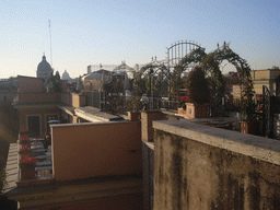 View from Piazza della Trinità dei Monti square on a rooftop garden, the San Carlo al Corso church and St. Peter`s Basilica