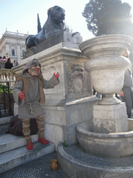 Statue of an Egyptian Lion at the foot of the Capitoline Hill, with a street artist