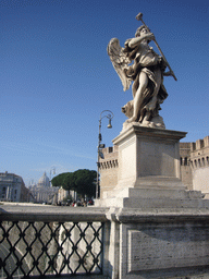 Statue on the Ponte Sant`Angelo bridge, and view on St. Peter`s Basilica