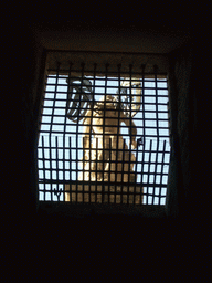 The back side of the marble statue of Saint Michael at the Castel Sant`Angelo, through a window