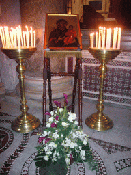 Painting, candles and flowers in the Basilica di Santa Maria in Trastevere church