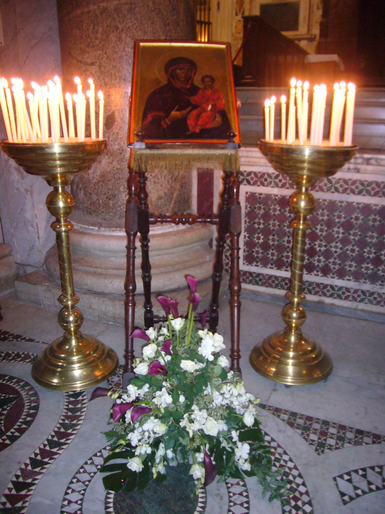 Painting, candles and flowers in the Basilica di Santa Maria in Trastevere church
