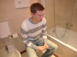 Tim on the toilet of our room in the hotel `Domina Hotel & Conference Capannelle`