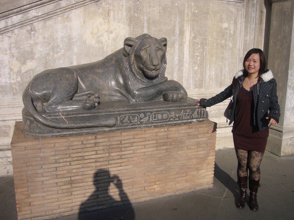 Miaomiao with an Egyptian statue of a lion, at the Cortile della Pigna square, at the Vatican Museums