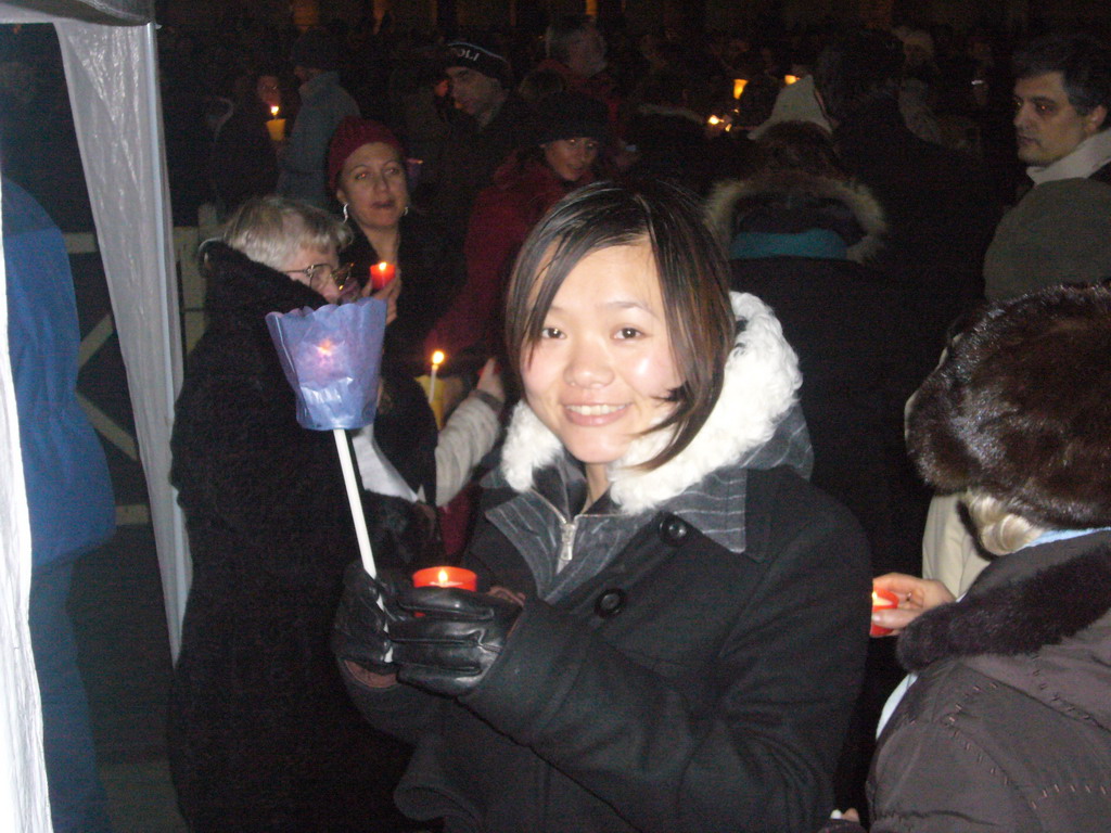 Miaomiao holding two candles at Saint Peter`s Square, at New Year`s Eve