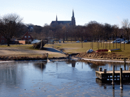 The Museum Harbour of the Viking Ship Museum, a viking ship, the Byparken park and the Roskilde Cathedral, viewed from the drawbridge