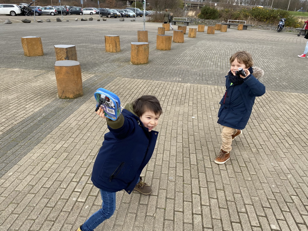 Max and his friend with their toys in front of the entrance to the Diergaarde Blijdorp zoo at the Blijdorplaan street