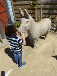 Max with a donkey statue in front of the chip twister restaurant at the South America area at the Diergaarde Blijdorp zoo