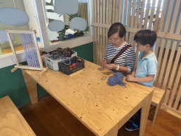 Miaomiao and Max playing with textile at the Stop! Monsters! exhibition at the lower floor of the Villa Zebra museum