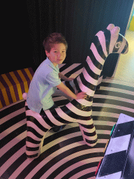 Max on a zebra statue at the ZELF! exhibition at the lower floor of the Villa Zebra museum