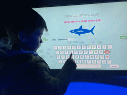 Max with a screen at the exhibition about the underwater world at the Oceanium at the Diergaarde Blijdorp zoo