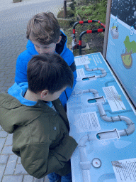 Max and his friend playing a game about water preservation in front of the Rivièrahal building at the Africa area at the Diergaarde Blijdorp zoo