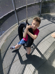 Max hanging on a tyre at the playground at the Monkey building at the Dierenwijck area of the Plaswijckpark recreation park