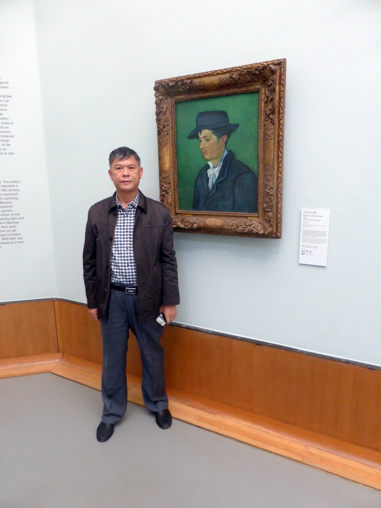 Miaomiao`s father with the painting `Portrait of Armand Roulin` by Vincent van Gogh, at the First Floor of the Museum Boijmans van Beuningen, with explanation