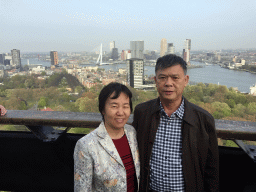 Miaomiaos`s parents at the lower viewing platform of the Euromast tower, with a view on the Park, the Westerlaantoren tower, the Erasmusbrug bridge over the Nieuwe Maas river and skyscrapers in the city center