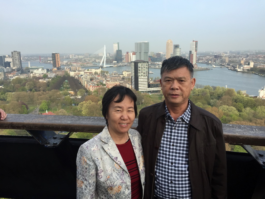 Miaomiaos`s parents at the lower viewing platform of the Euromast tower, with a view on the Park, the Westerlaantoren tower, the Erasmusbrug bridge over the Nieuwe Maas river and skyscrapers in the city center