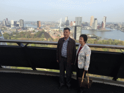 Miaomiaos`s parents at the lower viewing platform of the Euromast tower, with a view on the Park, the Westerlaantoren tower, the Erasmusbrug bridge over the Nieuwe Maas river and skyscrapers in the city center