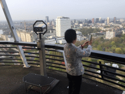 Miaomiao`s mother at the upper viewing platform of the Euromast tower, with a view on the Park, the Erasmus MC hospital and skyscrapers in the city center