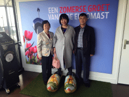 Miaomiao and her parents in wooden shoes, at the entrance to the viewing platforms of the Euromast tower