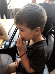 Max eating a churro at our lunch restaurant 21 Pinchos in the Markthal building