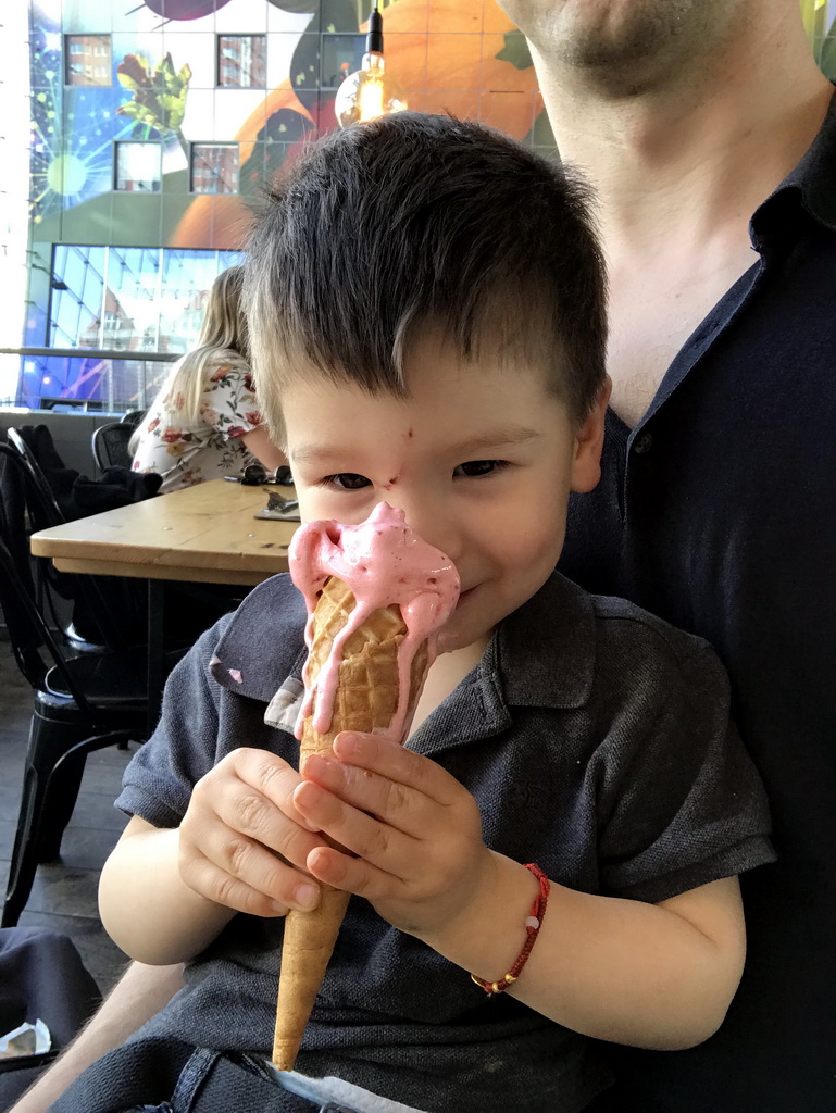 Max eating an ice cream at our lunch restaurant 21 Pinchos in the Markthal building