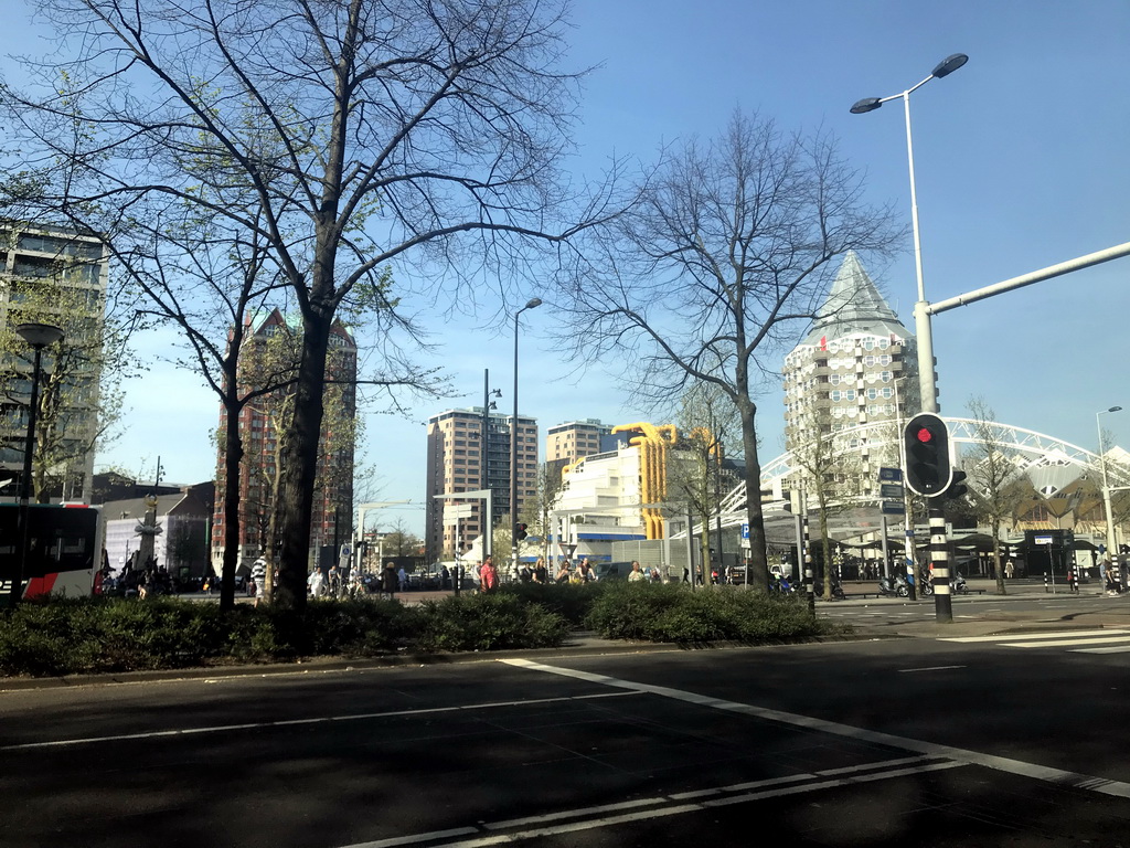 The Binnenrotte square with the Markthal building, the Blaaktoren tower, the Rotterdam Blaak Railway Station and the Kubuswoningen buildings, viewed from the car on the Blaak street