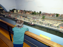 Max with miniature houses at the Marendam area at Miniworld Rotterdam