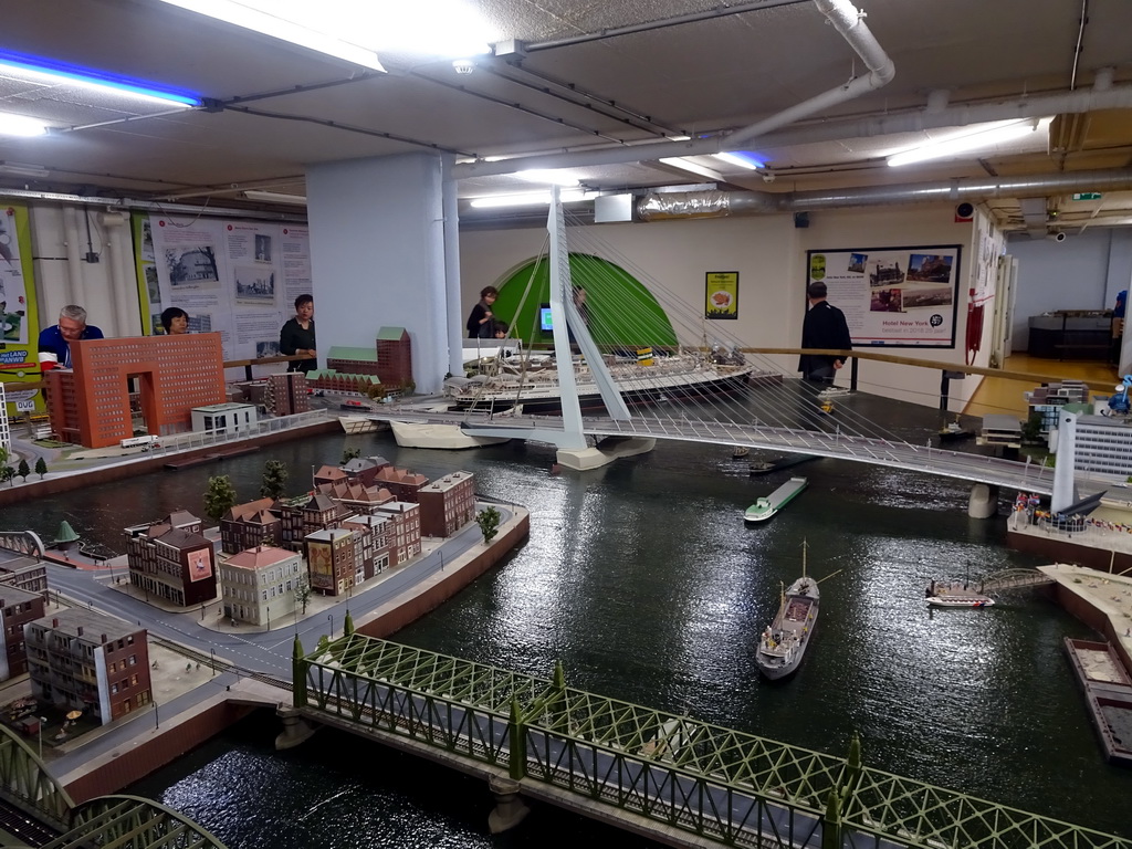 Miaomiao and her parents with the Erasmusbrug bridge at Miniworld Rotterdam