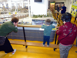 Max, Miaomiao and Miaomiao`s mother looking at a scale model of the Ahoy Rotterdam building at Miniworld Rotterdam