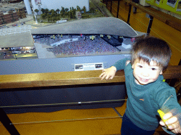 Max in front of a scale model of the Ahoy Rotterdam building at Miniworld Rotterdam, with explanation