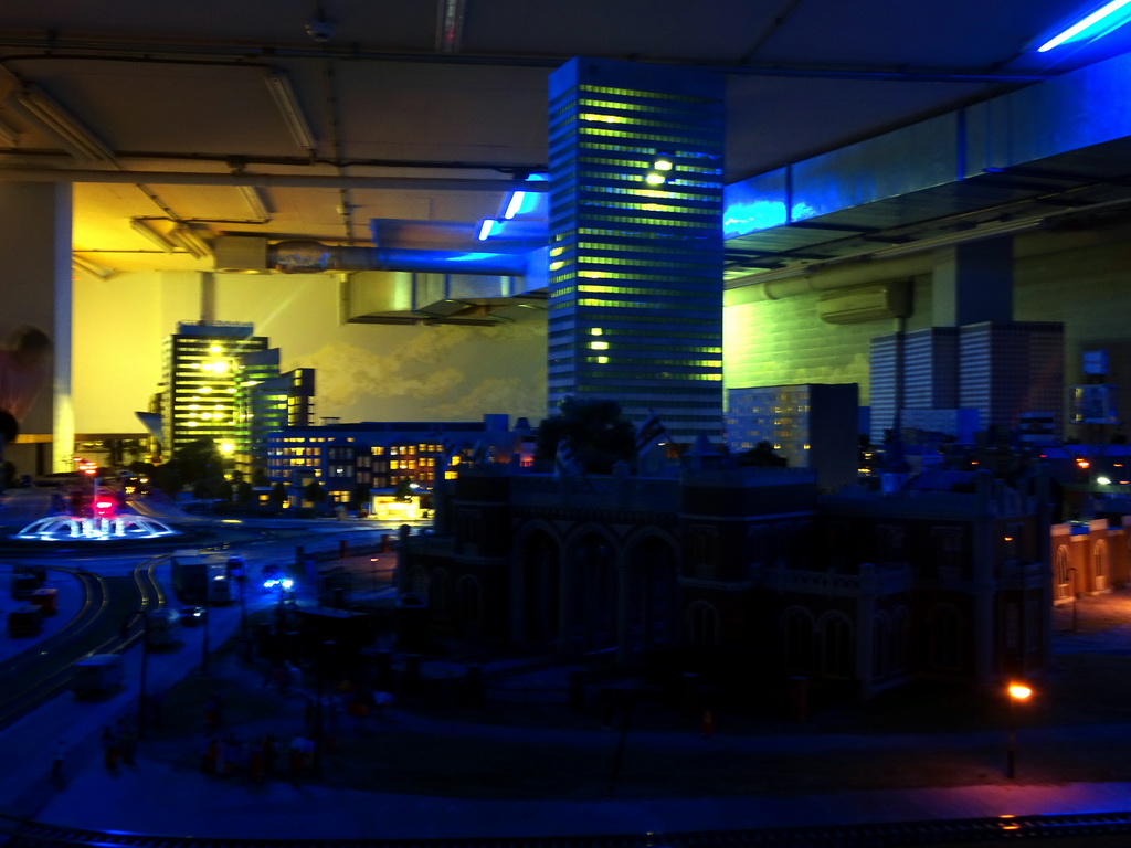 Scale models of the Rotterdam Delftsche Poort Railway Station and the Hofpoort building at Miniworld Rotterdam, in the dark