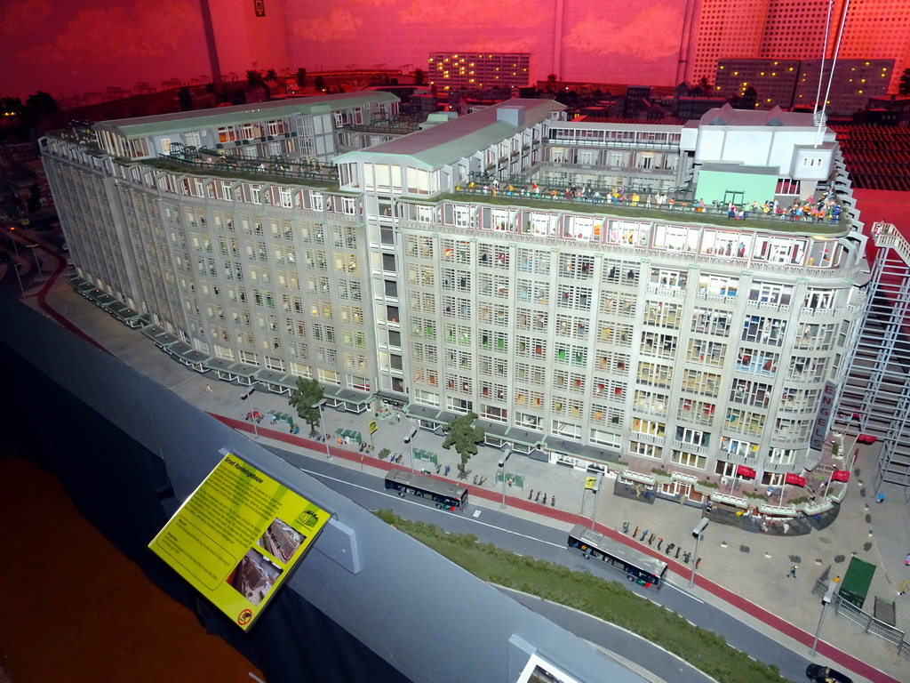 Scale model of the Groothandelsgebouw building at Miniworld Rotterdam, with explanation, in the dark