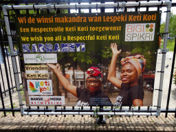 Poster on the Keti Koti festival at the entrance to the park at the West-Kruiskade street
