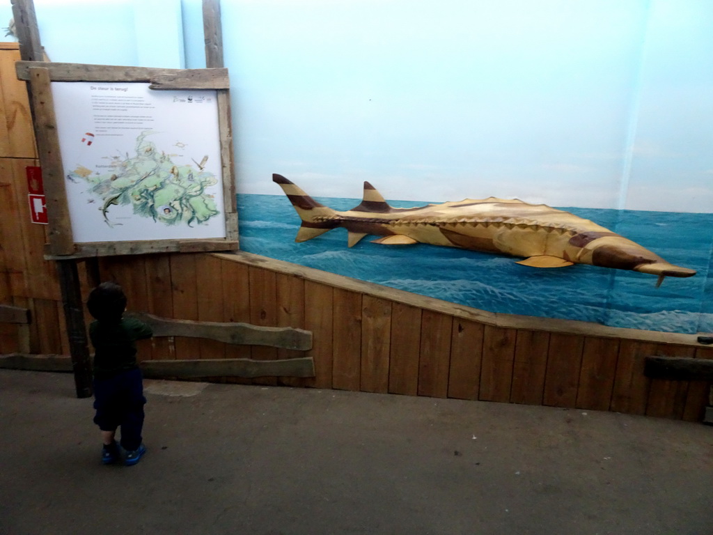 Max with a statue of a Sturgeon at the Oceanium at the Diergaarde Blijdorp zoo