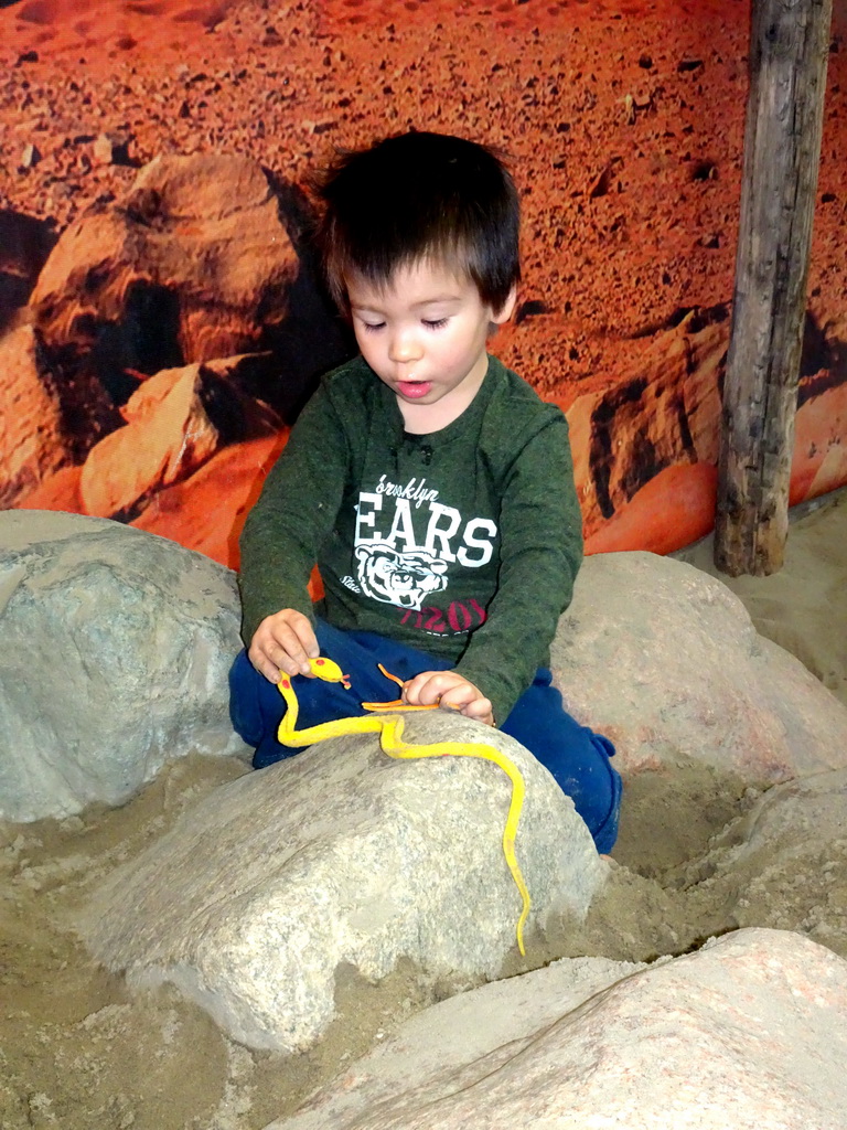Max playing with a toy snake and octopus at the Biotopia playground in the Rivièrahal building at the Africa area at the Diergaarde Blijdorp zoo