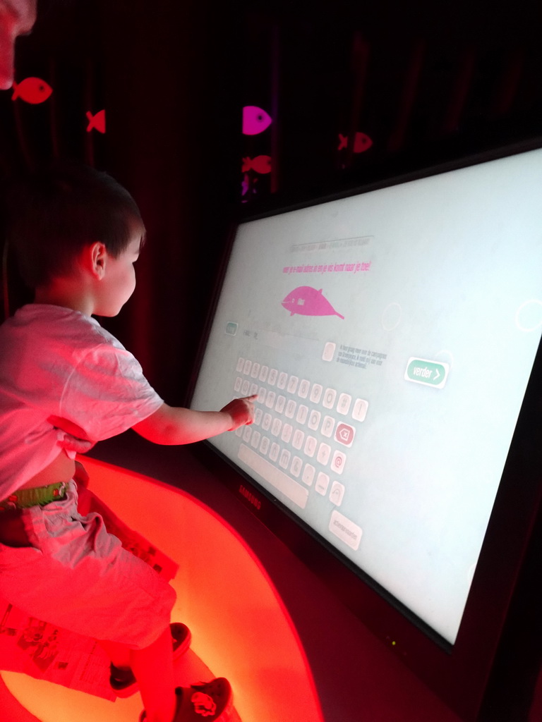 Max with a screen at the exhibition about the underwater world at the Oceanium at the Diergaarde Blijdorp zoo