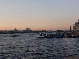 Boats in the Neva river and the Troitsky Bridge, at sunset