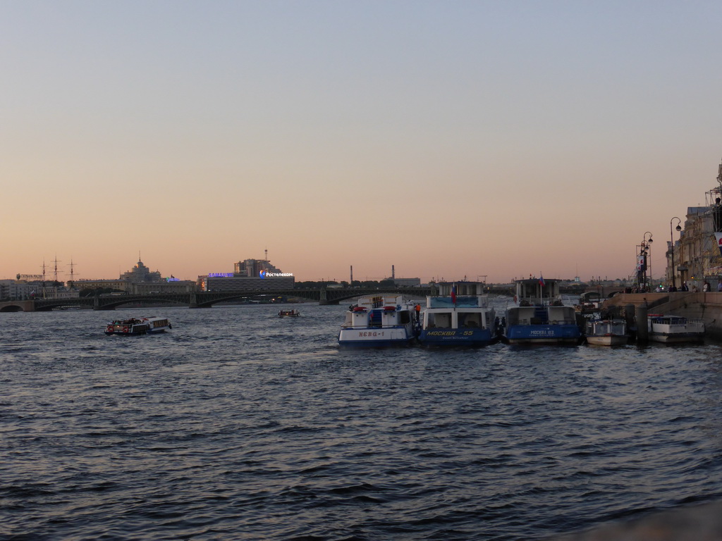 Boats in the Neva river and the Troitsky Bridge, at sunset
