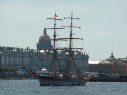 Boat in the Neva river, the front of the Winter Palace of the State Hermitage Museum and the dome of Saint Isaac`s Cathedral, viewed from the Ioannovsky Bridge