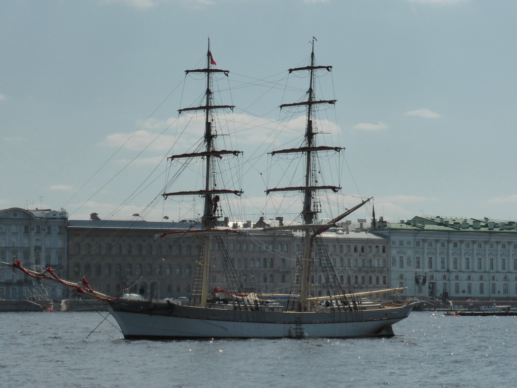 Boat in the Neva river and the front of the Winter Palace of the State Hermitage Museum, viewed from the Commandant`s Landing at the Peter and Paul Fortress