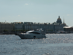 Boat in the Neva river, the front of the State Hermitage Museum, the tower of the Admiralty and the dome of Saint Isaac`s Cathedral, viewed from the Commandant`s Landing at the Peter and Paul Fortress