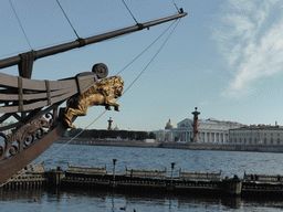 Prow of the restaurant boat `The Flying Dutchman` in the Neva river, the Old Saint Petersburg Stock Exchange, the Rostral Columns and the towers of the Admiralty and the Saint Isaac`s Cathedral