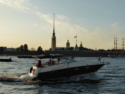 Boat in the Neva river and the Peter and Paul Fortress with the Peter and Paul Cathedral, the Grand-Ducal Burial Chapel and the Flagstaff Tower, viewed from the tour boat