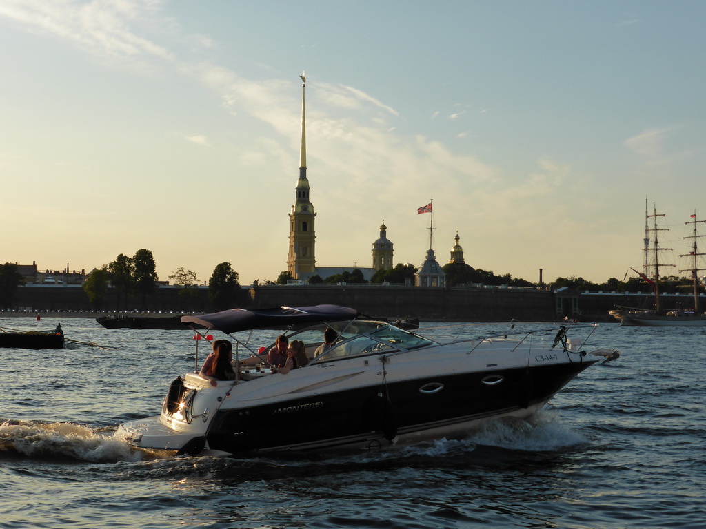 Boat in the Neva river and the Peter and Paul Fortress with the Peter and Paul Cathedral, the Grand-Ducal Burial Chapel and the Flagstaff Tower, viewed from the tour boat