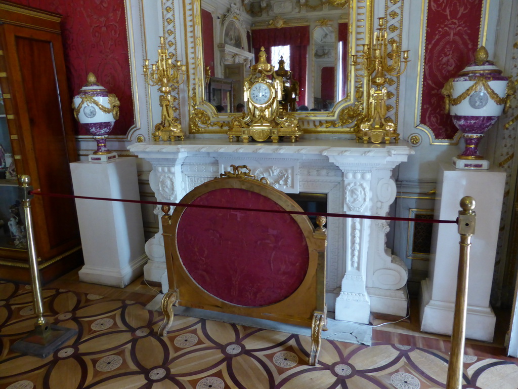 Mirror, clock, fireplace, vases and chandeleers in a room at the First Floor of the Winter Palace of the State Hermitage Museum